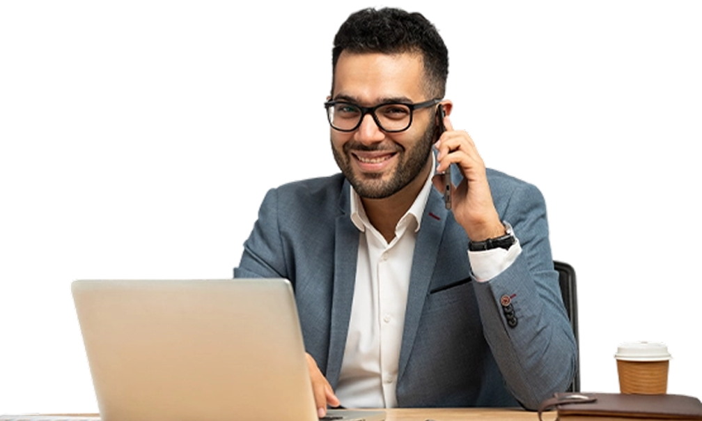 Smiling professional on a phone call at his laptop